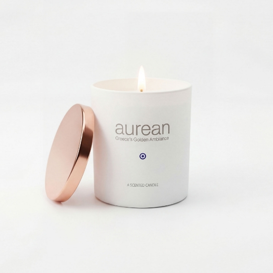 Lit Aurean Golden Lumos luxury candle in a white matte vessel with a rose gold lid, handcrafted for elenianna.