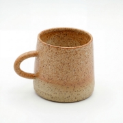 Handcrafted speckled ceramic coffee mug with rustic earth-tone glaze and ergonomic handle